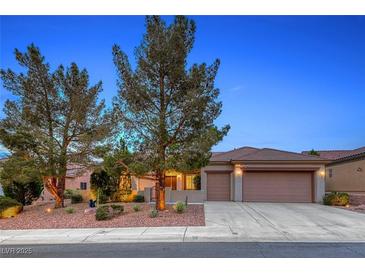 Charming single-story home with desert landscaping, mature trees, and a two-car garage at 2850 Thunder Bay Ave, Henderson, NV 89052