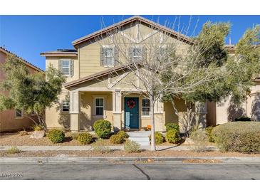 Inviting two-story home featuring well-maintained landscaping and a charming front entrance with a blue door and seasonal wreath at 3232 Romanesque Art Ave, Henderson, NV 89044