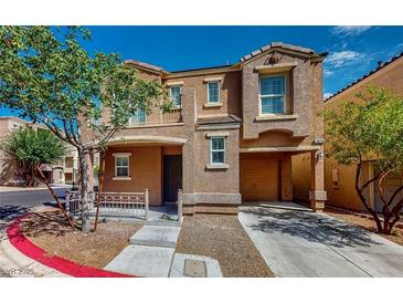 Inviting two-story home with a warm, earthy facade and an attached garage at 3820 Ice Storm Ct, Las Vegas, NV 89129