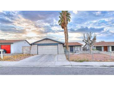 Modest single-story home featuring a two-car garage and xeriscaped front yard at 4145 Plumtree St, Las Vegas, NV 89115