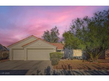 Charming single-story home with a two-car garage, desert landscaping, and vibrant sunset sky at 4620 Standing Bluff Way, Las Vegas, NV 89130