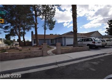 Charming single-story home with a well-manicured front yard and a two-car garage in a residential neighborhood at 5901 Oceanside Way, Las Vegas, NV 89108