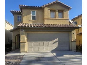 Two-story home featuring a large two car garage, stucco siding, and a tile roof at 6182 Blue Rapids Ct, Las Vegas, NV 89139
