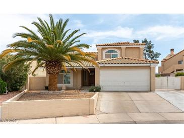 Charming two-story home featuring a well-manicured front yard and a two car garage at 730 Rusty Spur Dr, Henderson, NV 89014