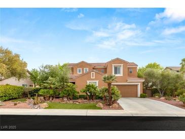 Charming two-story home with a well-manicured lawn, lush landscaping, and a two-car garage at 9 Contra Costa Pl, Henderson, NV 89052