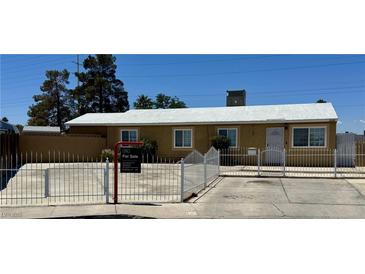 Charming single-story home featuring a new roof, white fence and desert landscaping at 5157 New Bedford Dr, Las Vegas, NV 89122
