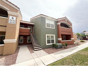 Condo building with multiple units, a stairway, and desert landscaping around the complex at 8101 W Flamingo Rd # 1044, Las Vegas, NV 89147