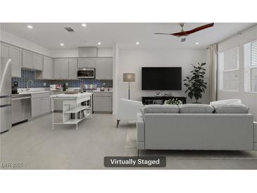 Open-concept living room showcasing a modern kitchen and comfortable seating area, virtually staged at 1103 Tektite Ave, Henderson, NV 89011