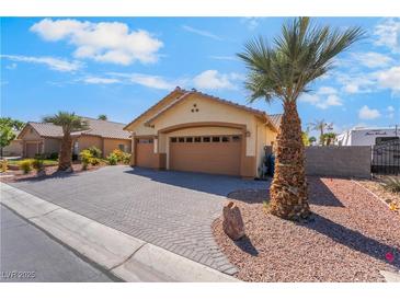 Charming home featuring a spacious driveway, desert landscaping, and a two-car garage at 1363 Yeager Ave, Las Vegas, NV 89123