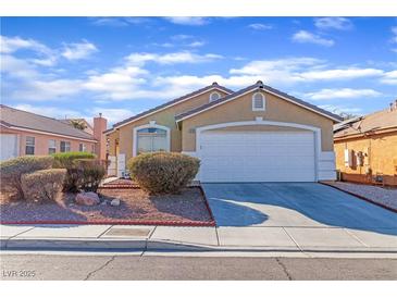 Charming single-story home featuring a well-manicured lawn, a two-car garage, and a welcoming facade at 3741 Round Robin St, North Las Vegas, NV 89032