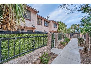 Charming two-story townhome with well-maintained landscaping and gated entrance at 4338 Caliente St # 11, Las Vegas, NV 89119