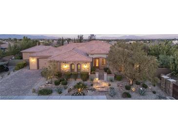 Stunning single-story home with stone accents, manicured landscaping, and a paver driveway at 5410 Serenity Brook Dr, Las Vegas, NV 89149