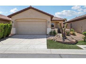 Charming single-story home featuring a two-car garage, landscaped front yard, and well-maintained exterior at 6059 Wheat Penny Ave, Las Vegas, NV 89122
