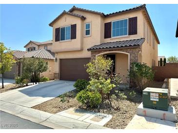 Charming two-story home featuring a two-car garage, covered porch, and desert landscaping at 7253 Blooming Jasmine Ave, Las Vegas, NV 89117