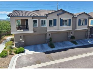 Charming townhome showcasing a tile roof, paired shutters, and a well-maintained front yard at 7334 N Decatur Blvd # 6, Las Vegas, NV 89131