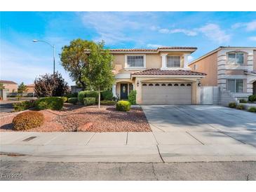 Charming two-story home with a well-manicured lawn and a two-car garage at 810 Socorro Song Ln, Henderson, NV 89052