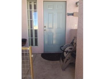 Charming entry with a light blue front door and adjacent window, leading into the home at 10525 Autumn Pine Ave # 203, Las Vegas, NV 89144