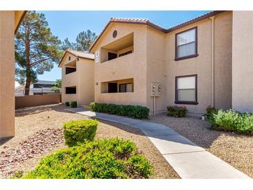 Inviting exterior view of a tan apartment complex with well-maintained landscaping and walkways at 2451 N Rainbow Blvd # 1016, Las Vegas, NV 89108