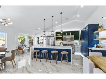 Modern kitchen with a large island, stainless steel appliances, and beautiful marble flooring at 2652 Golfside Dr, Las Vegas, NV 89134