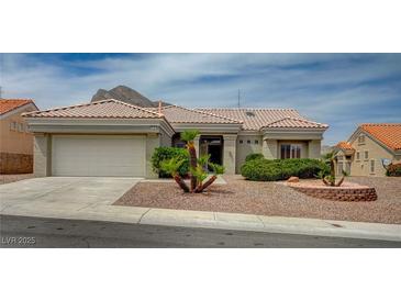Charming single-story home featuring a tile roof, desert landscaping, and an attached two-car garage at 2721 Faiss Dr, Las Vegas, NV 89134