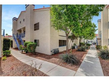 Inviting condo exterior featuring well-maintained landscaping and charming architectural details at 2725 S Nellis Blvd # 1052, Las Vegas, NV 89121