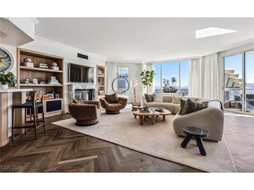 Bright living room features a fireplace, herringbone floors, city views, and stylish contemporary decor at 2857 Paradise Rd # 2203, Las Vegas, NV 89109