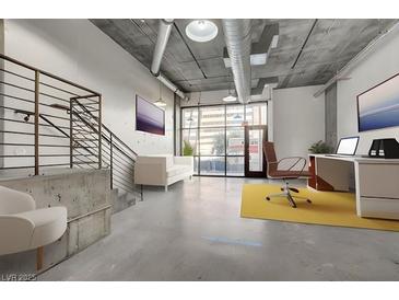 Spacious living area featuring concrete floors, industrial style ceilings, and modern furniture at 353 E Bonneville Ave # 181/281, Las Vegas, NV 89101