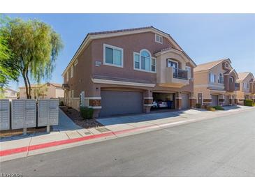 A tan-colored two-story home with a small balcony and a two-car garage at 4808 Straight Flush Dr # 103, Las Vegas, NV 89122