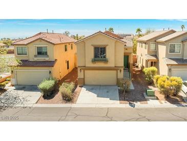 Inviting home with a two-car garage and well-maintained front yard landscaping at 8453 Cheerful Brook Ave, Las Vegas, NV 89143
