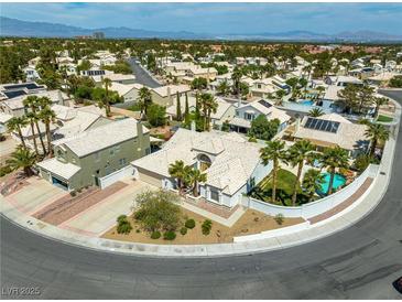 Expansive single-story home with a private pool, set in a lushly landscaped neighborhood with mountain views at 2212 Marble Gorge Dr, Las Vegas, NV 89117