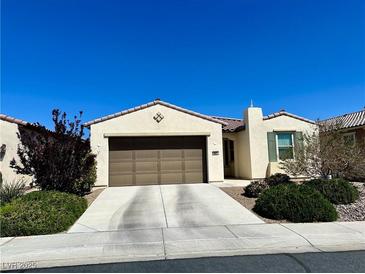 Charming single-story home featuring a two-car garage, desert landscaping, and a terracotta tile roof at 3624 Corte Bella Hills Ave, North Las Vegas, NV 89081