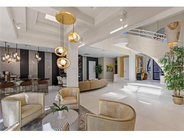 Stunning living room with unique chandelier, and modern design elements throughout at 8109 Moonstone Cir, Las Vegas, NV 89128