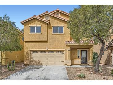 Two-story home with an attached two-car garage and a well-manicured front yard at 9651 Bouncing Ball St, Las Vegas, NV 89178