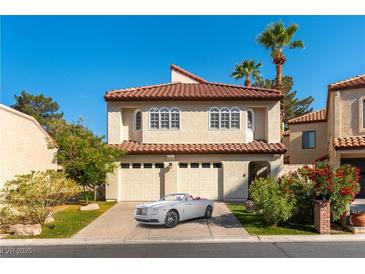 Charming two-story home with a two-car garage, terra cotta roof, and well-maintained landscaping at 2845 Queens Courtyard Dr, Las Vegas, NV 89109