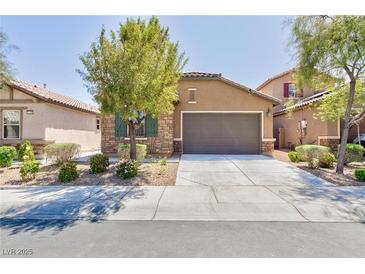 Charming single-story home featuring a stone facade and a well-maintained front yard with mature landscaping at 7137 Flowering Rose Ave, Las Vegas, NV 89117