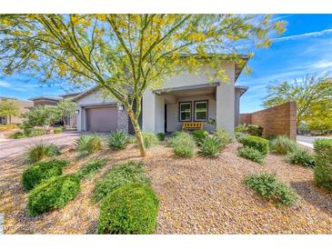 Inviting single-story home with a beautifully landscaped front yard and a stone driveway at 109 Reverie Heights Ave, Henderson, NV 89011