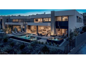 Stunning modern home featuring a luxurious pool, spa, and outdoor entertaining area with comfortable seating at 29 Falling Ridge Ln, Henderson, NV 89011