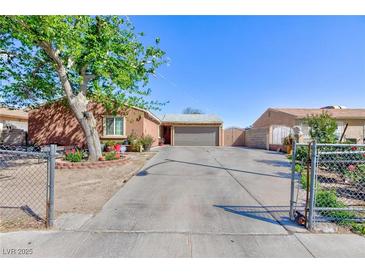 Charming single-story home with a large driveway, fenced yard, and mature trees at 3814 Connie Ave, Las Vegas, NV 89115