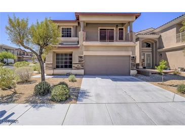 Charming two-story home featuring a spacious garage and lovely balcony, complemented by desert landscaping at 6709 Barrington Hills St, Las Vegas, NV 89149