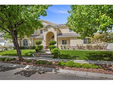 Charming two-story home with an immaculate lawn, mature trees, and inviting curb appeal at 7460 Grassy Field Ct, Las Vegas, NV 89131