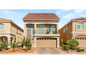 Charming two-story home features a red-tile roof, balcony, and a two-car garage with paver driveway at 8276 Sorrel St, Las Vegas, NV 89139
