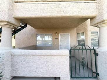 A welcoming entrance with a secure gated porch area and views of the stairway at 8410 Eldora Ave # 1003, Las Vegas, NV 89117