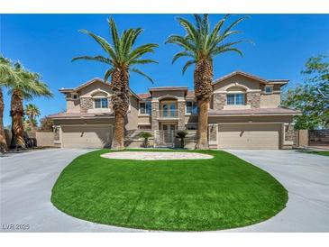Beautiful two-story home featuring a circular driveway and two majestic palm trees framing the entrance at 9504 Empire Rock St, Las Vegas, NV 89143
