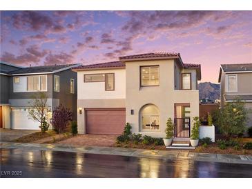 Beautiful two-story home featuring a modern design, red brick driveway, and desert landscaping at 1208 Crimson Sunbird St, North Las Vegas, NV 89084