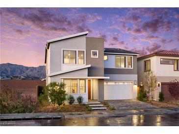 Modern two-story home featuring stylish architecture and well-manicured landscaping against a stunning sunset backdrop at 1212 Crimson Sunbird St, North Las Vegas, NV 89084
