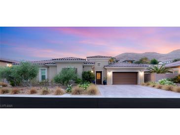 Stunning single-story home featuring a tiled roof, desert landscaping and a two car garage at 21 Grand Masters Dr, Las Vegas, NV 89141