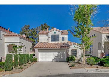 Charming two-story stucco home featuring a red tile roof and attached two-car garage at 2212 Warm Walnut Dr, Las Vegas, NV 89134