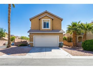 Charming two-story home featuring a neutral stucco finish, desert landscaping, and a convenient two-car garage at 2608 Los Palos St, Las Vegas, NV 89108