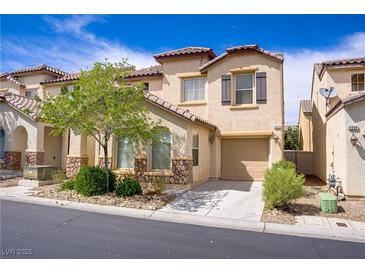 Charming two-story townhome featuring desert landscaping, a private driveway, and an attached one car garage at 4972 Groveland Ave, Las Vegas, NV 89139
