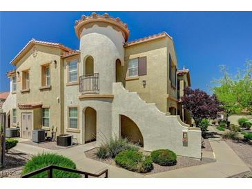 Charming condo with a stucco exterior, private balcony, and desert landscaping at 50 Aura De Blanco St # 19103, Henderson, NV 89074